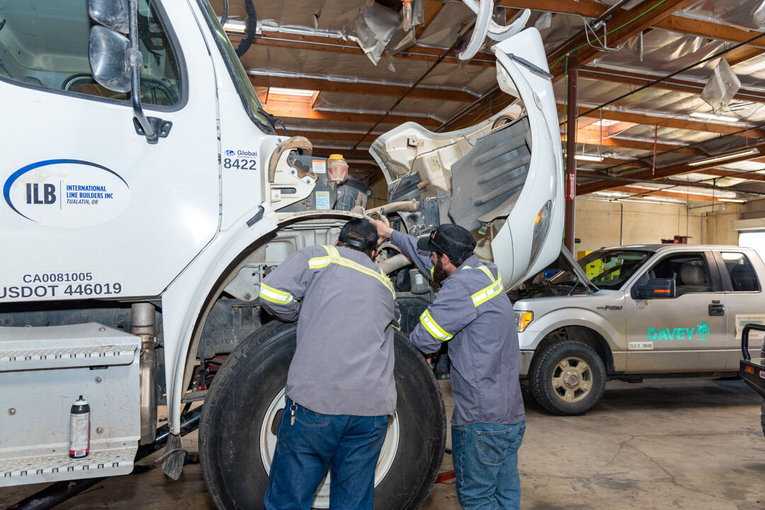 Mechanic working on truck hydraulic system